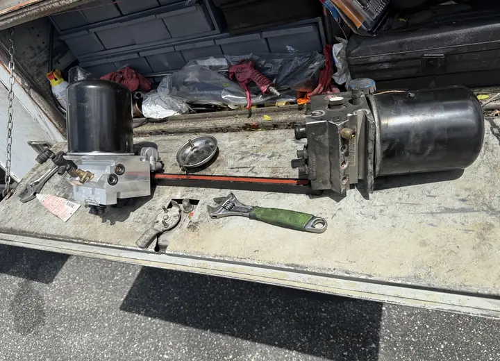 New and removed heavy-duty truck air-dryer assemblies during mobile repair