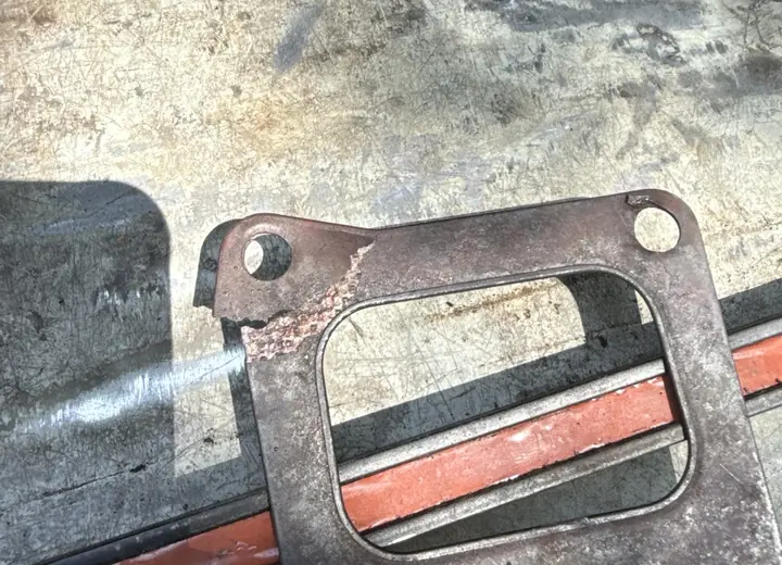 Cracked heavy-duty diesel exhaust flange gasket found during teardown
