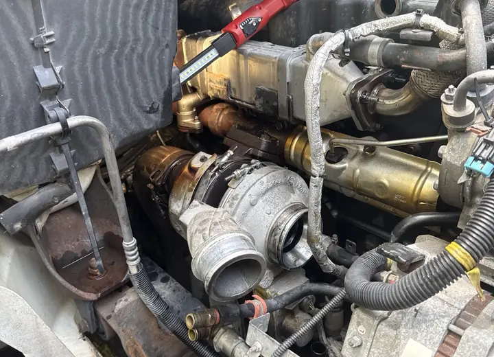 Heavy-duty diesel turbocharger opened for inspection during mobile repair